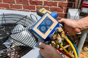 Technician inspecting an outdoor AC unit at a Boulder County home